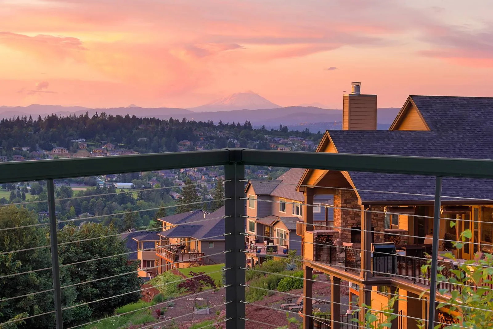 Cable railing deck with a mountain sunset