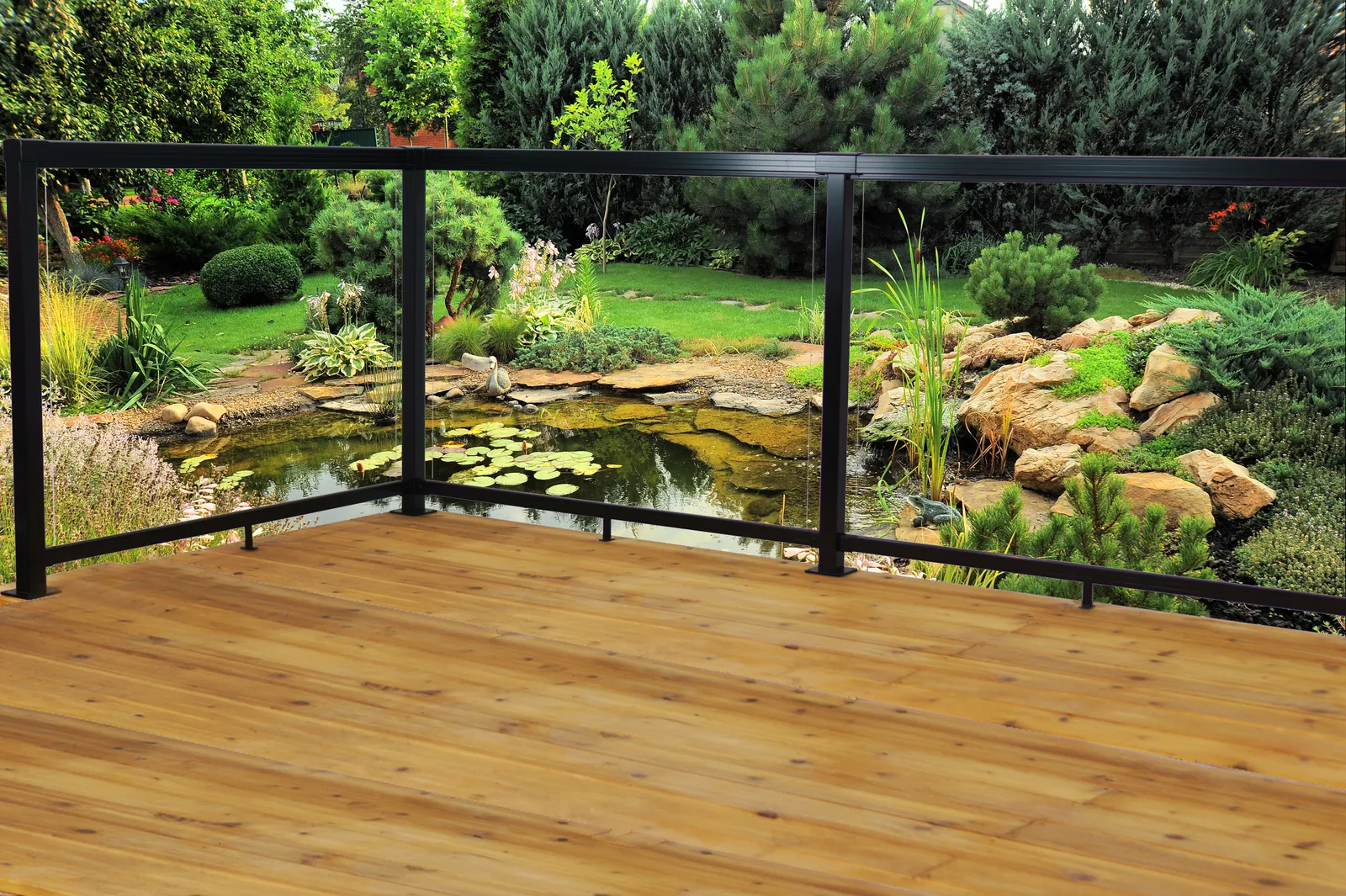 Glass railing deck above a garden pond