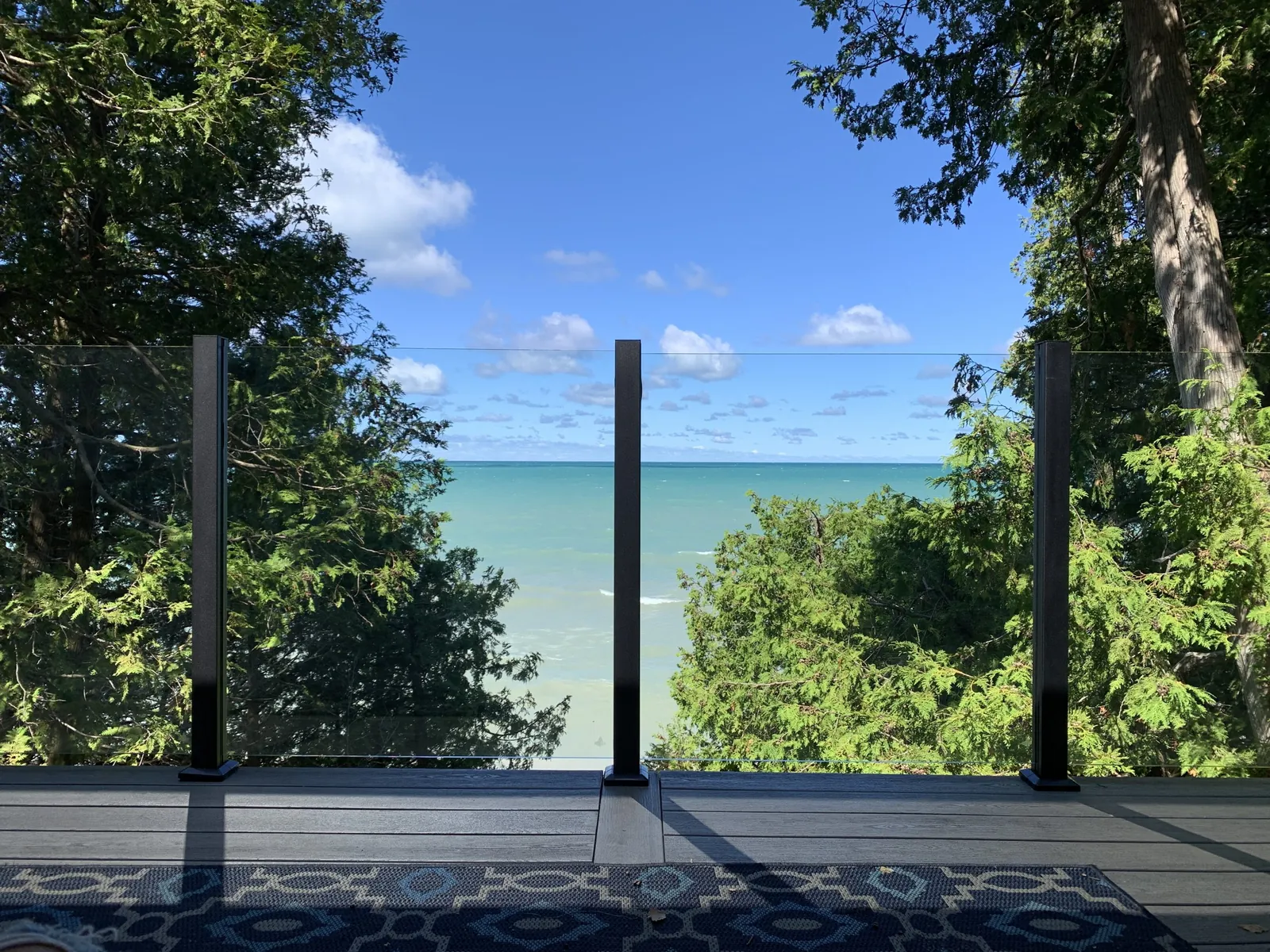 Glass railing deck framing a water view
