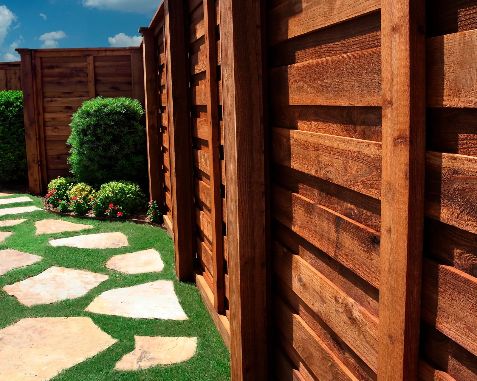 Horizontal cedar fence with stepping stones