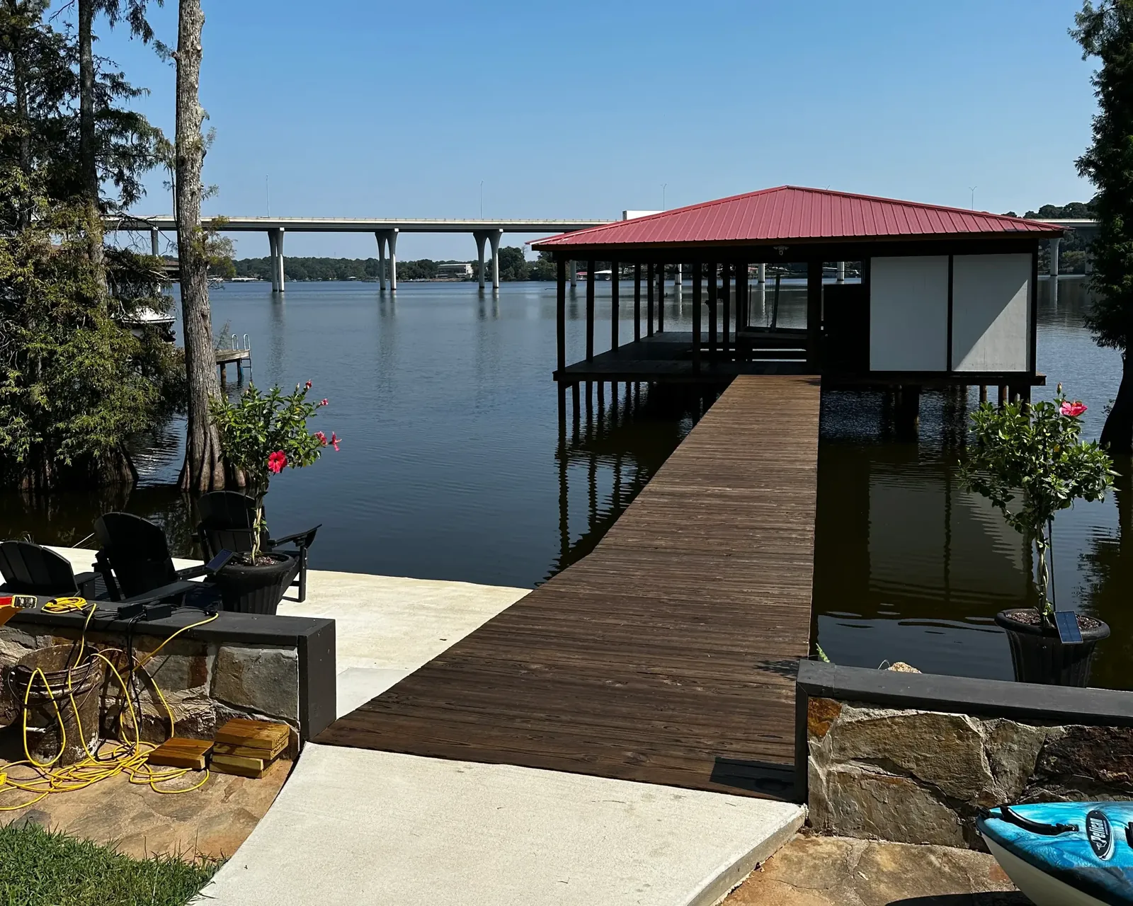 Lake dock walkway to a covered boathouse