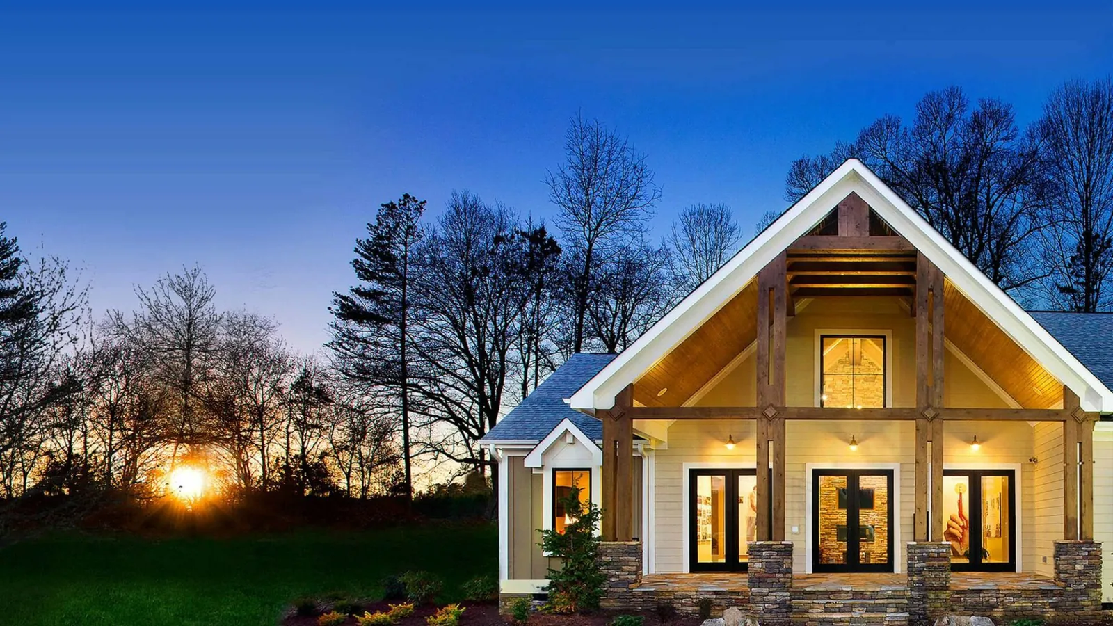 Craftsman home with wood-look soffit at sunset