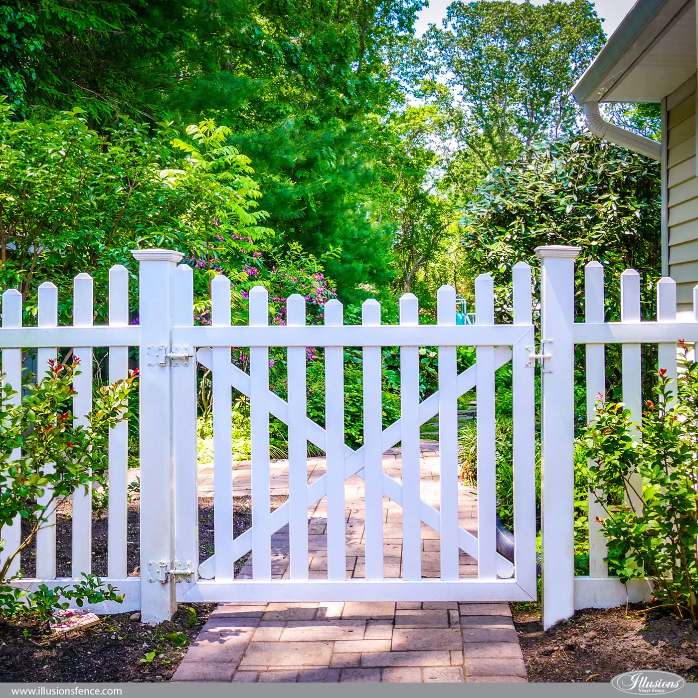Illusions white vinyl picket walk gate in a garden
