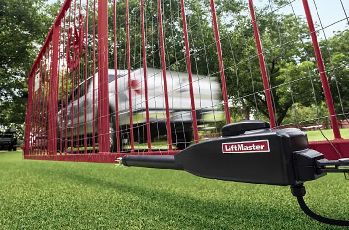 LiftMaster swing gate operator arm installed on a red swing gate