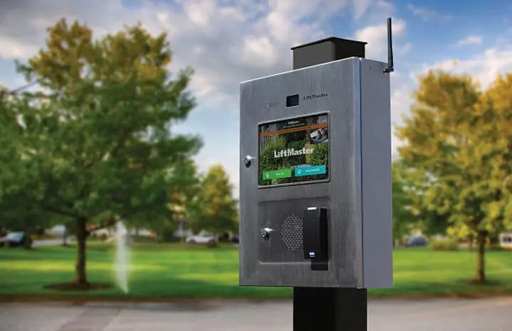 LiftMaster access control kiosk with video display beside a driveway