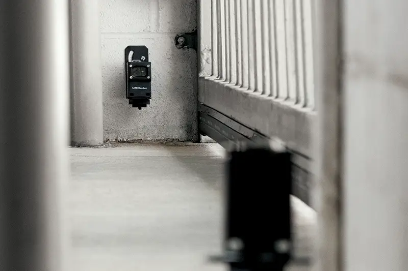 LiftMaster accessory installed beside a gate