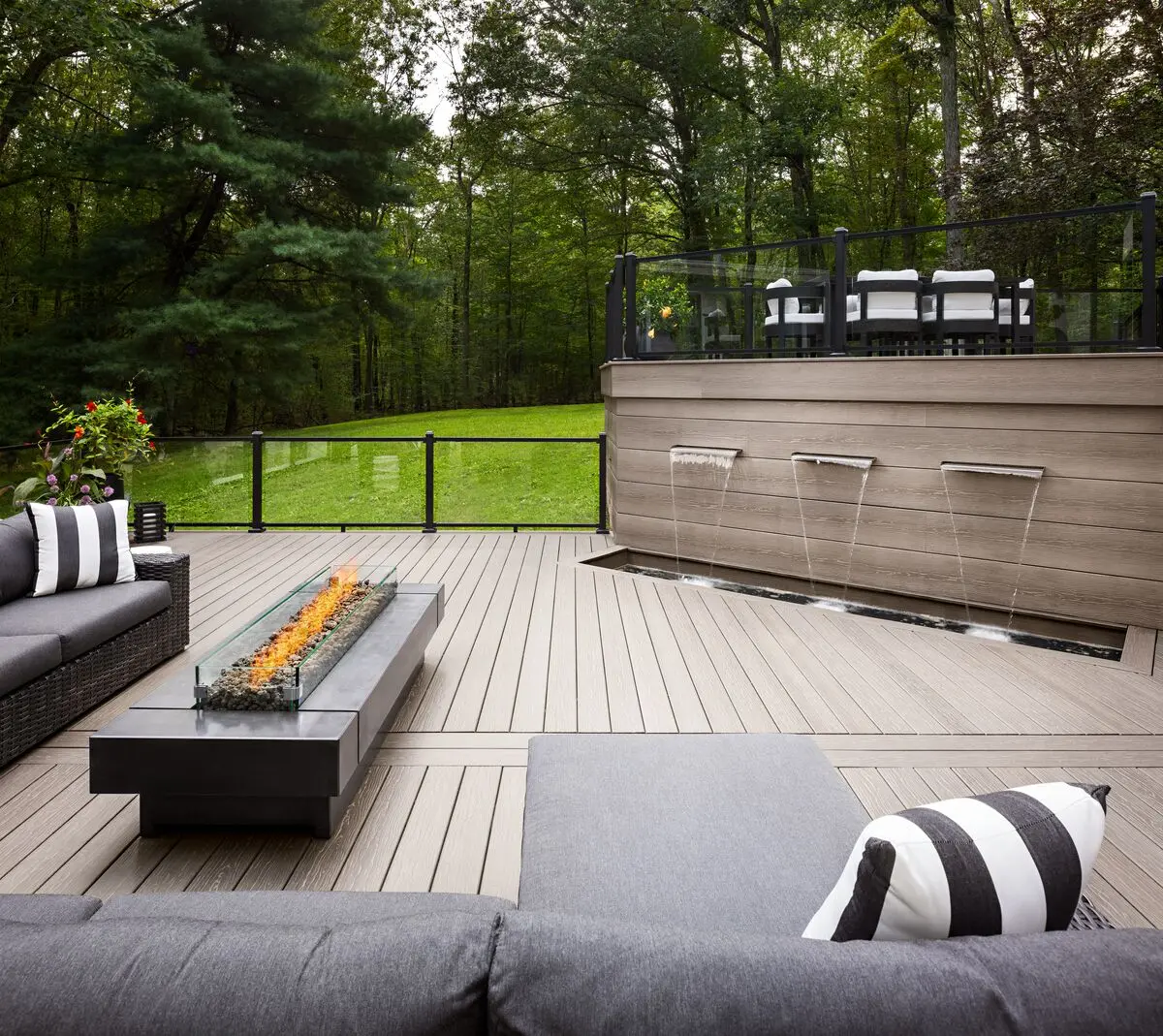 MoistureShield composite deck with glass panel railing and lounge seating