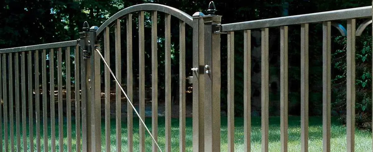Ornamental steel fence with arched gate and tall pickets