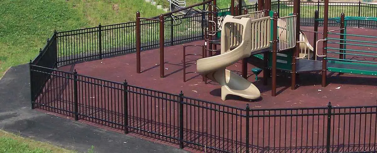 Black ornamental steel fence around a playground