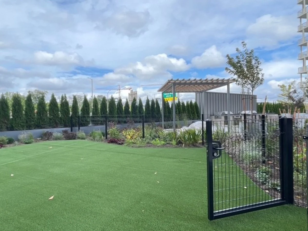 Black Designmaster Classic panel gate on a landscaped turf area