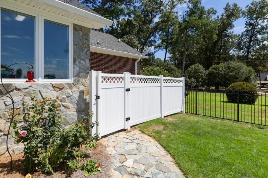 White vinyl fence section with matching gate