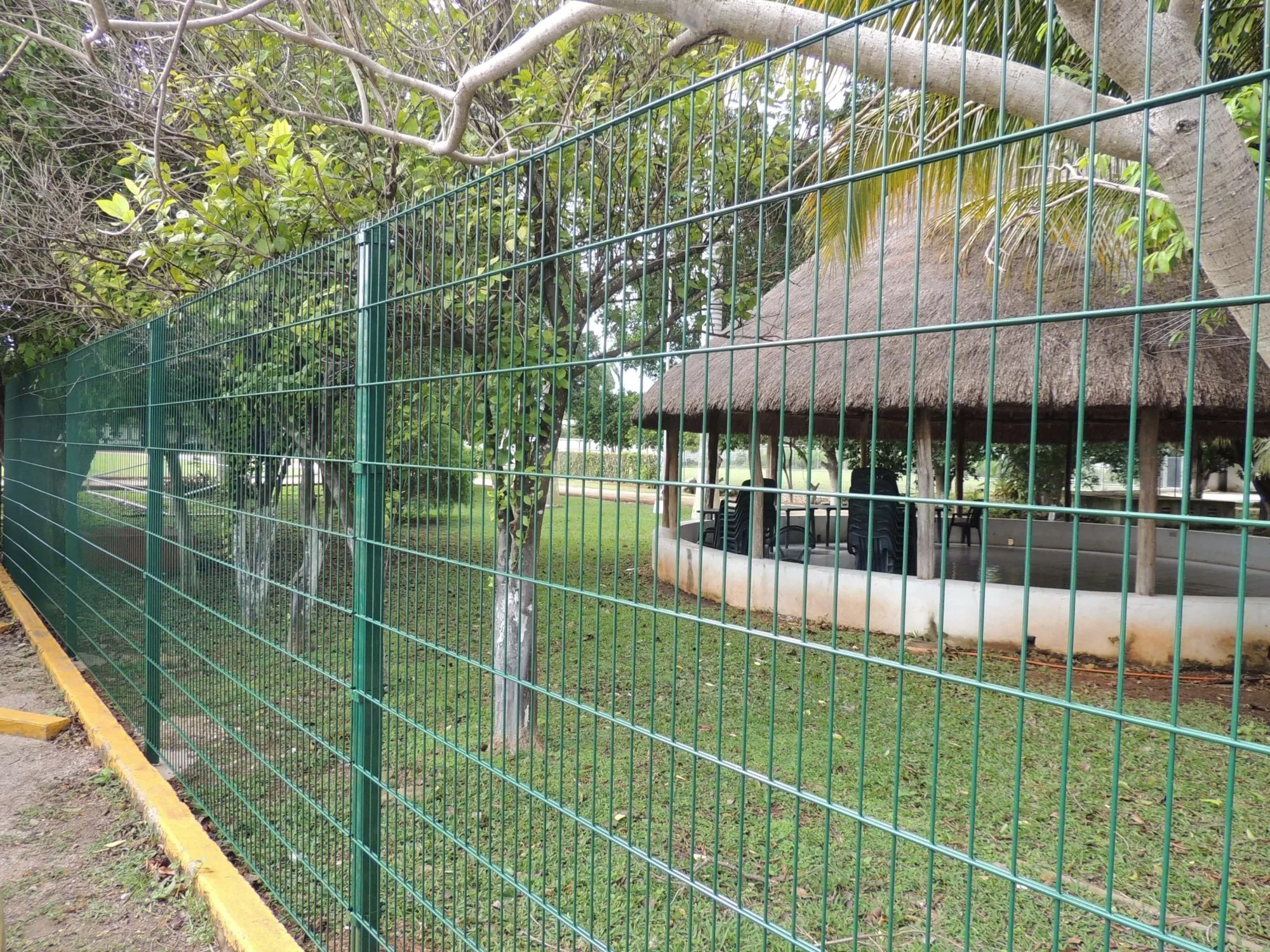 Green Designmaster welded wire fence at a park pavilion
