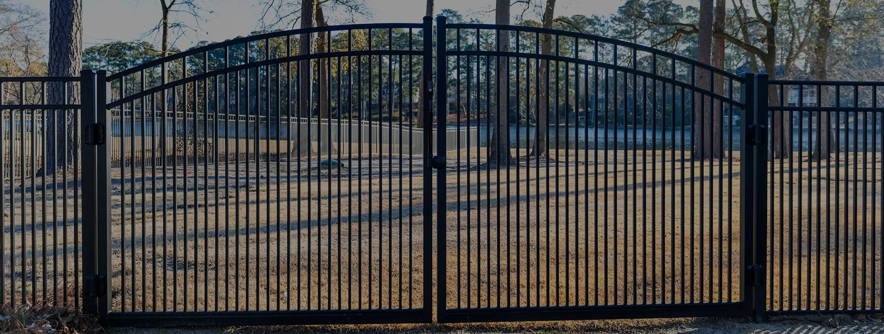 Wide arched custom ornamental double drive gate