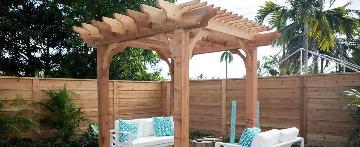 Horizontal wood fence with pergola and patio seating on PostMaster+ posts