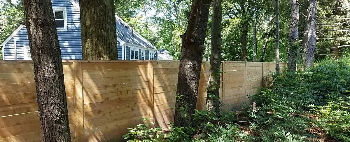 Wood plank fence among trees using PostMaster posts