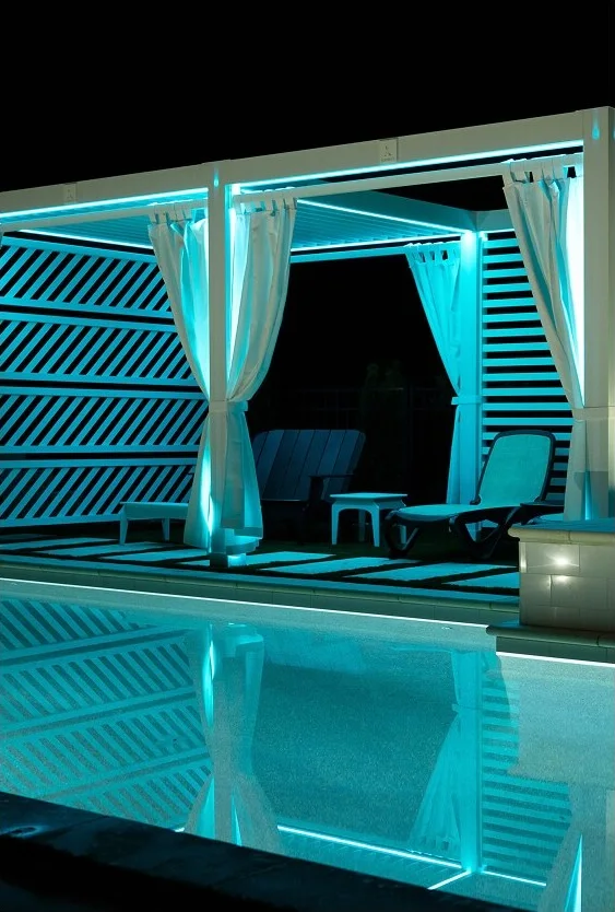 StruXure Cabana X MOD cabana lit with teal lights at night