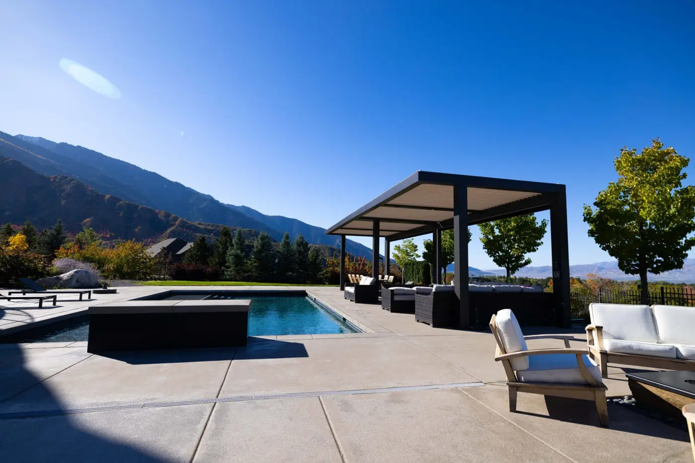 Modern pergola beside a pool with mountain views