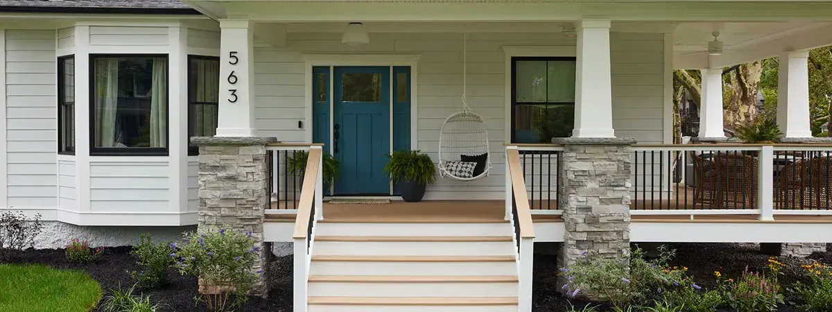TimberTech porch flooring on a covered front porch with stone columns