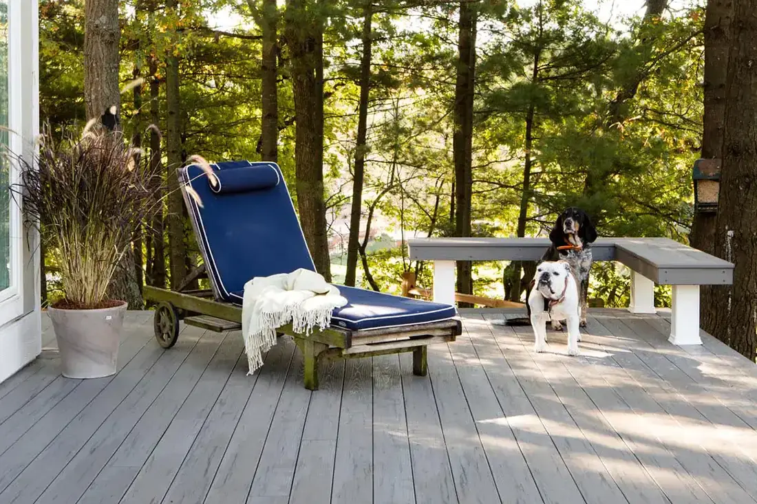 TimberTech gray composite deck in a wooded backyard