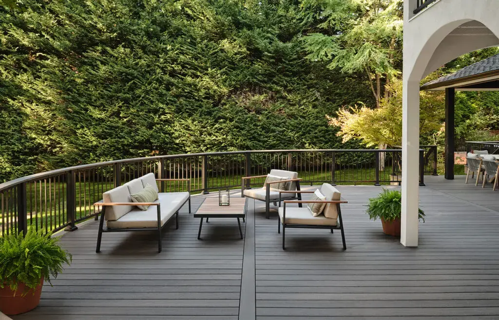 TimberTech gray composite deck with curved railing and patio furniture