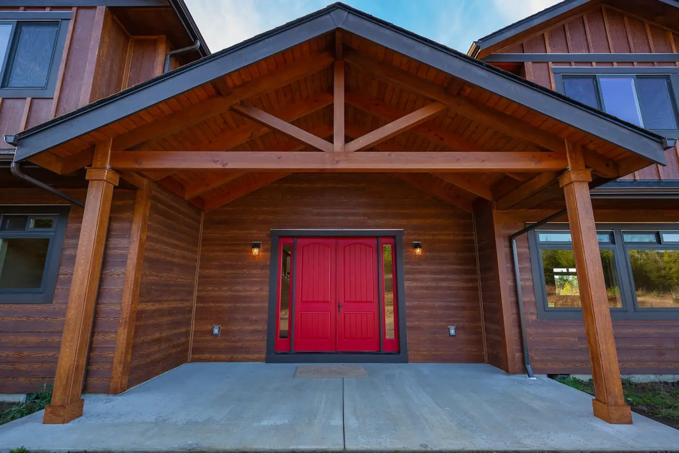 Timber frame entry porch with red front door
